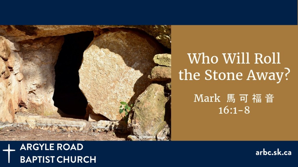 entrance to a rock cave with a round stone rolled partway across the entrance. The cave is all dark inside.