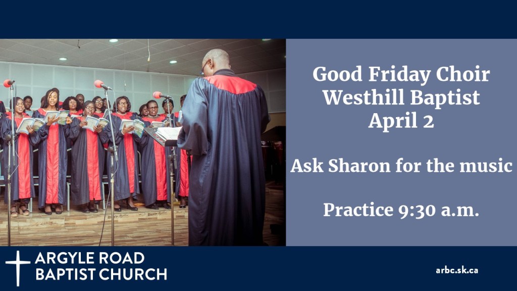 choir in choir gowns singing. The back of the choir director is in the foreground of the picture.