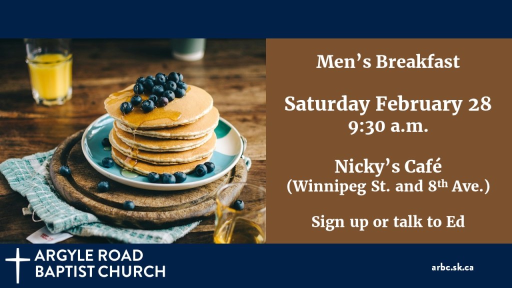 stack of pancakes with blueberries and syrup on a blue plate, with a glass or orange juice