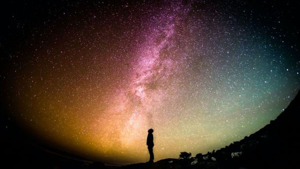 man looking up at the Milky Way