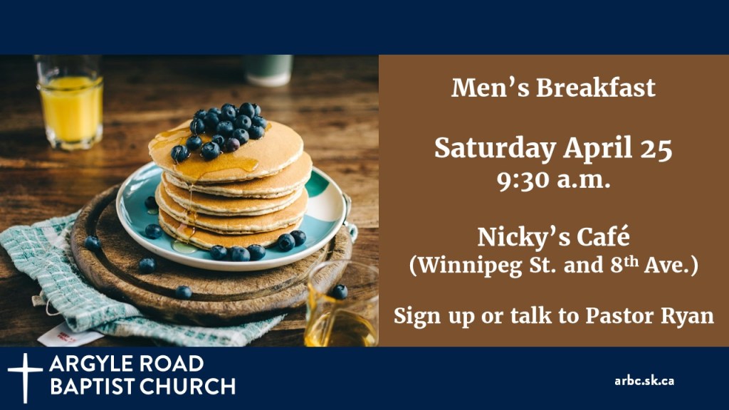 stack of pancakes with syrup and blueberries on a blue plate, with a glass of orange juice behind.