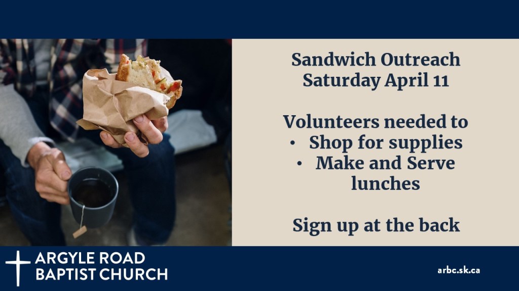 man holding a brown bag sandwich and a cup of tea.